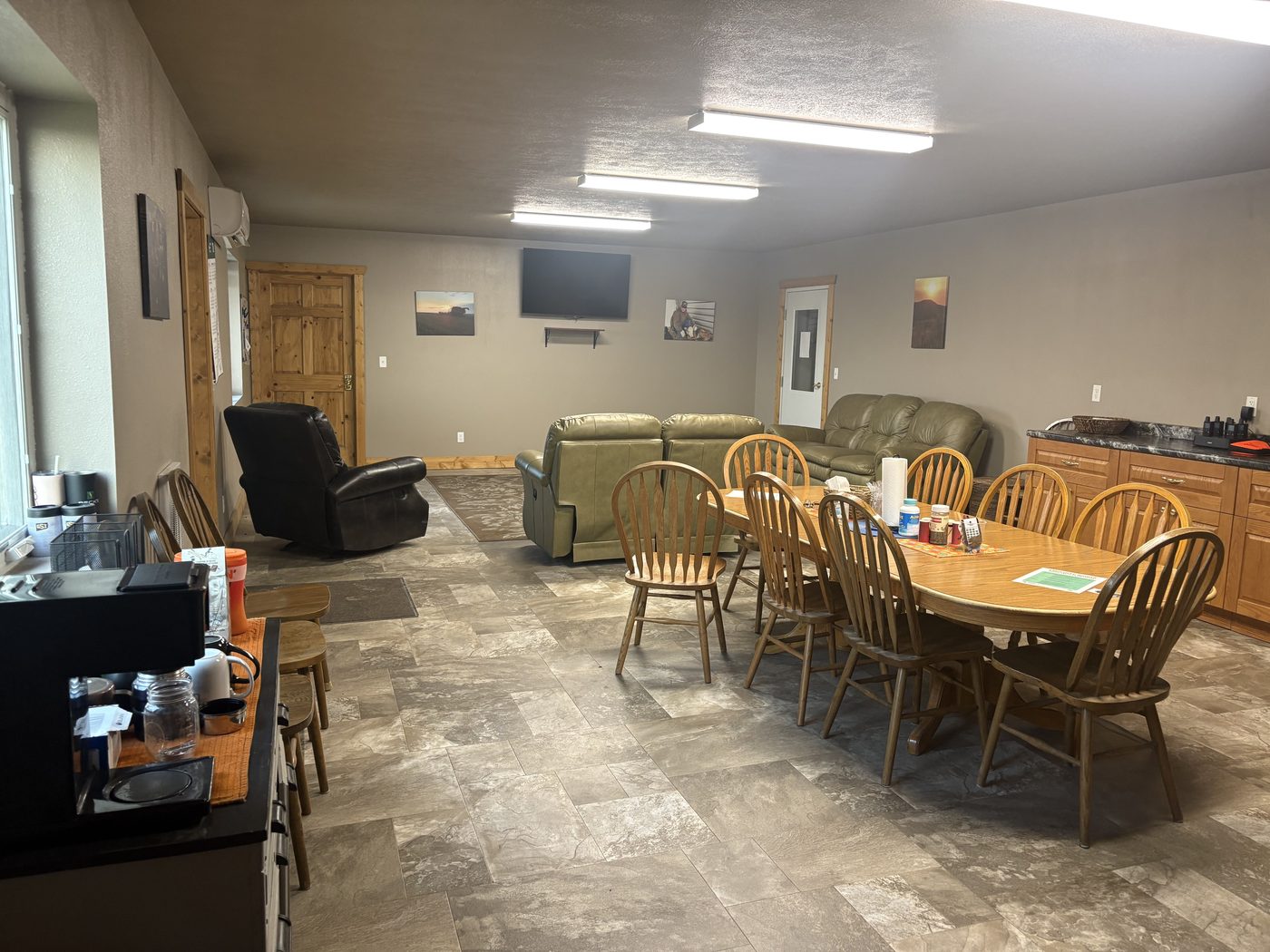 The bunkhouse common room with dining table and lounge seating