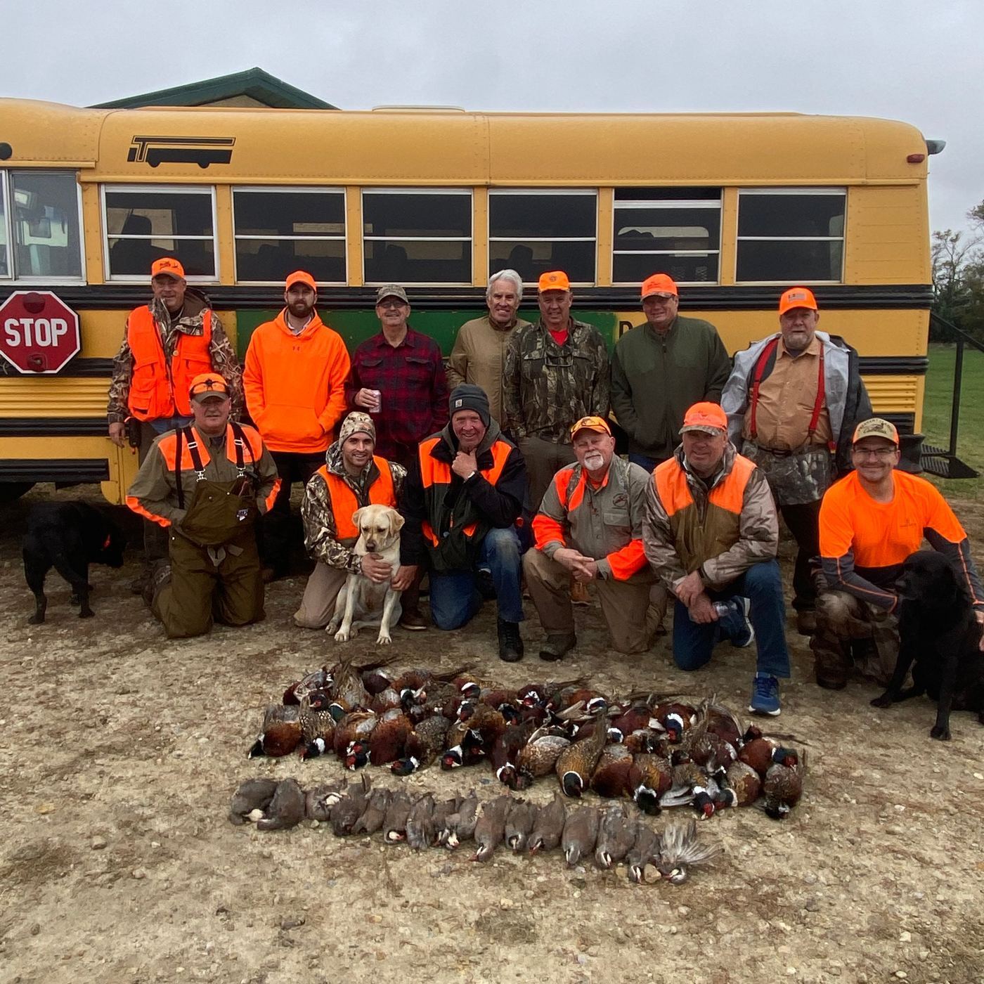 A hunting party with dogs and a limit of South Dakota roosters