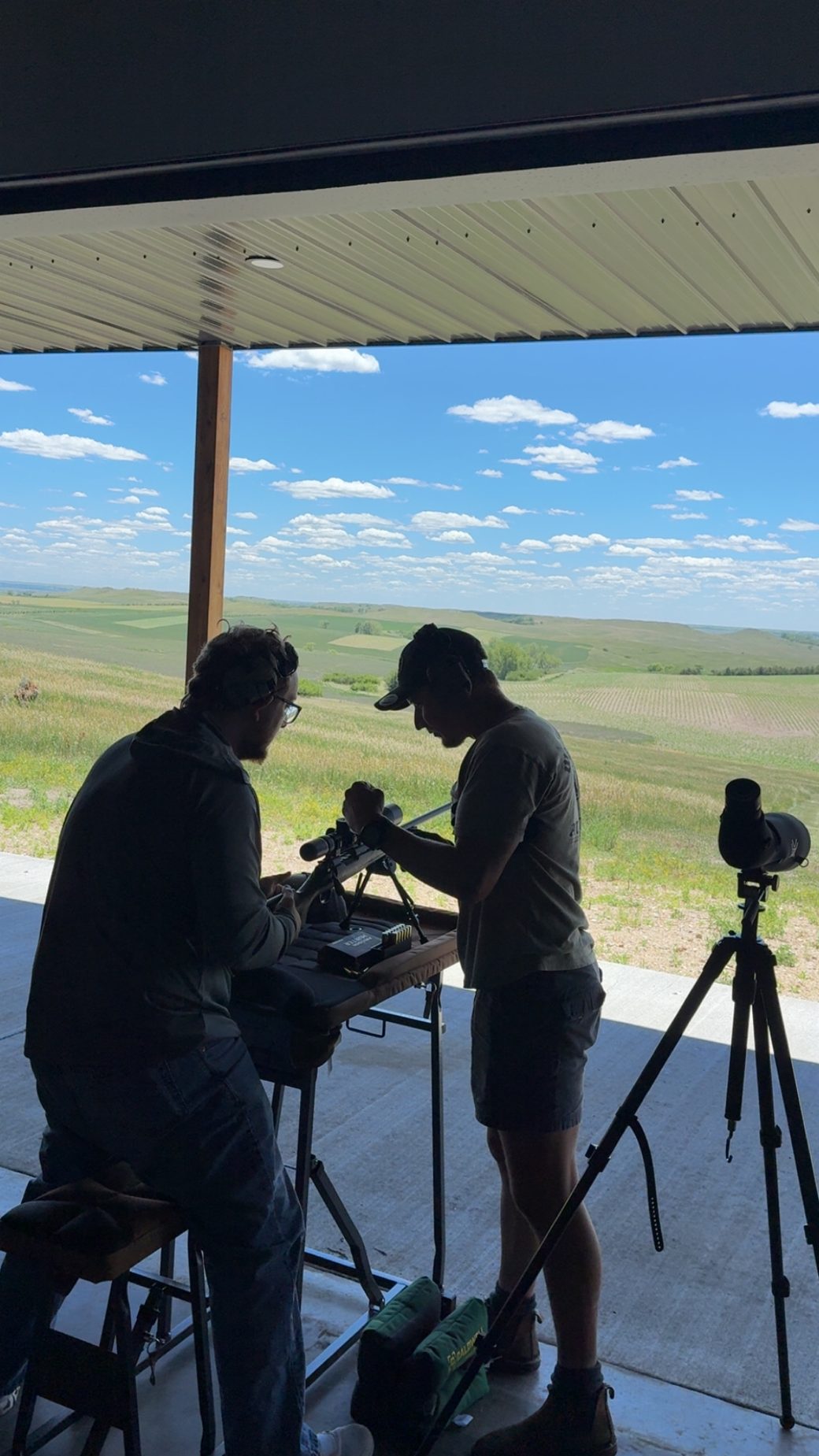 Two shooters and a spotting scope on the long-range benches