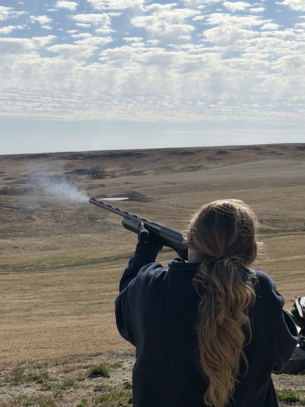 A guest breaking clays on the trap range at Bolton Ranch