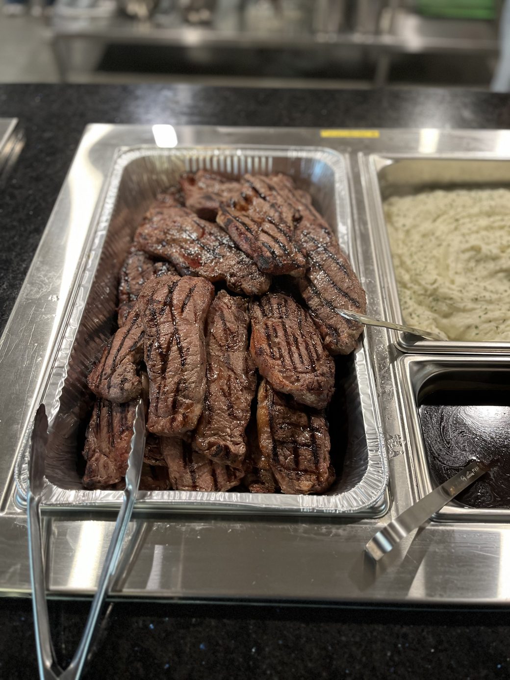 Steaks ready on the buffet at the lodge