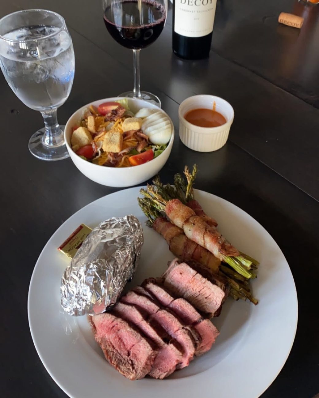 A plated supper with wine at the lodge table