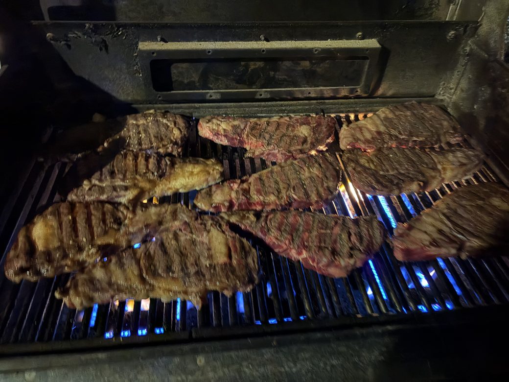 Steaks on the grill at The Lodge at Bolton Ranch